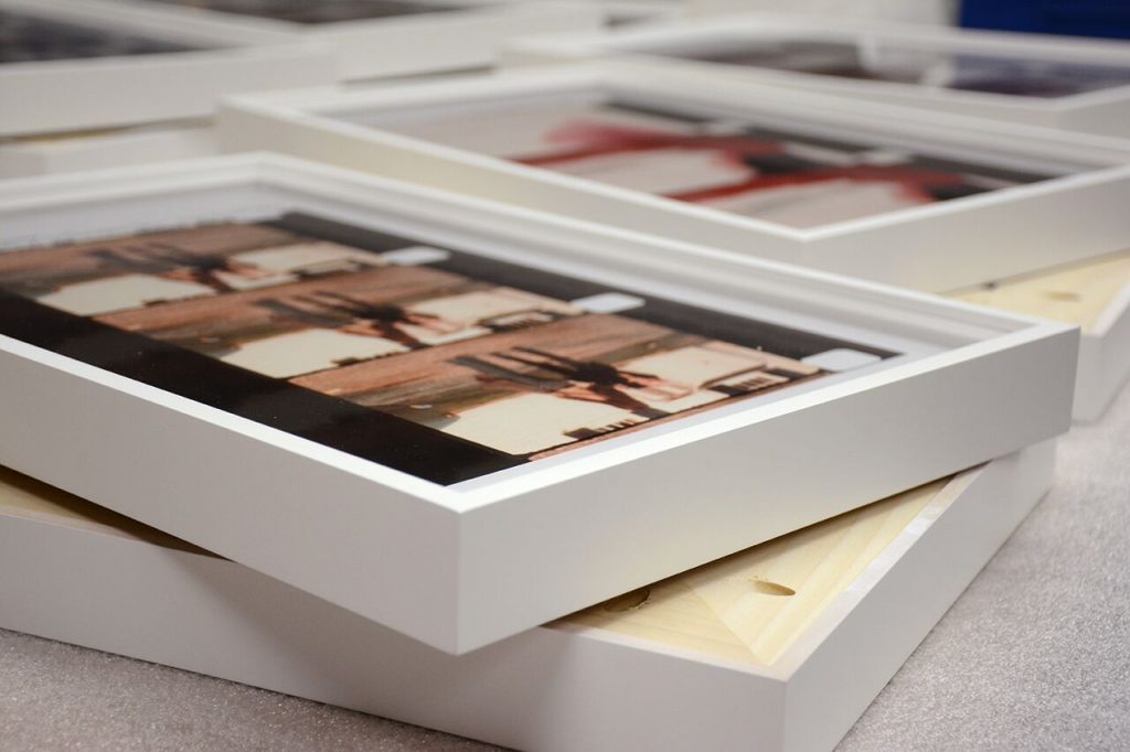 a stack of framed photos